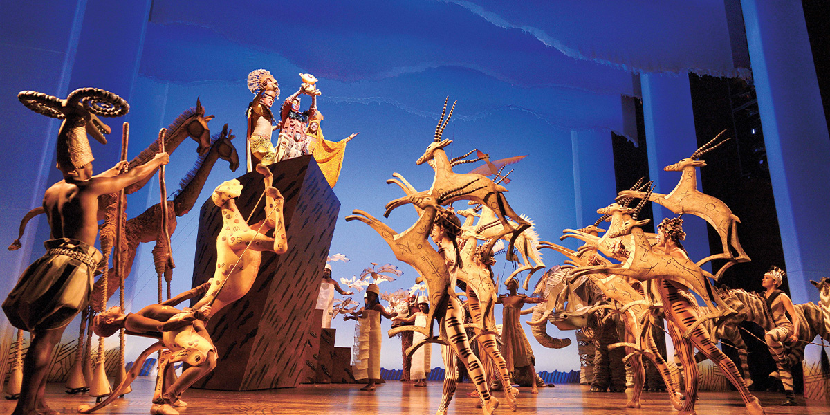 A vibrant illustration from Disney's The Lion King, featuring Simba and other characters in a lush savannah.