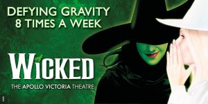 A promotional banner for "Wicked" featuring the show's title in bold green letters against a dark background.