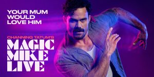 A dynamic performance scene from Magic Mike Live, featuring dancers in vibrant costumes and dramatic lighting.