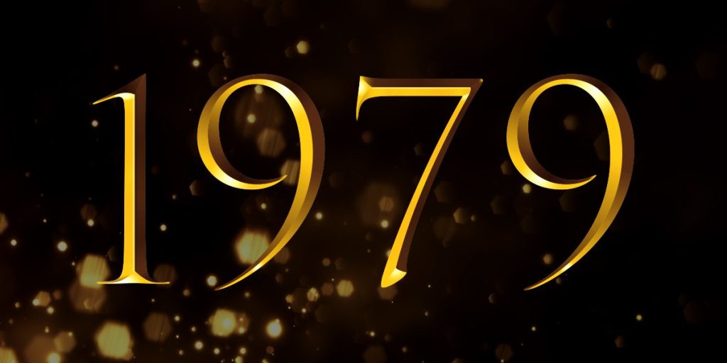 Golden text displaying "1979" against a dark background with shimmering golden particles.