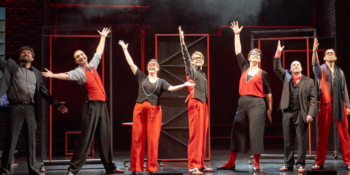 A vibrant stage scene with performers in colourful costumes, energetically engaging in a musical number.