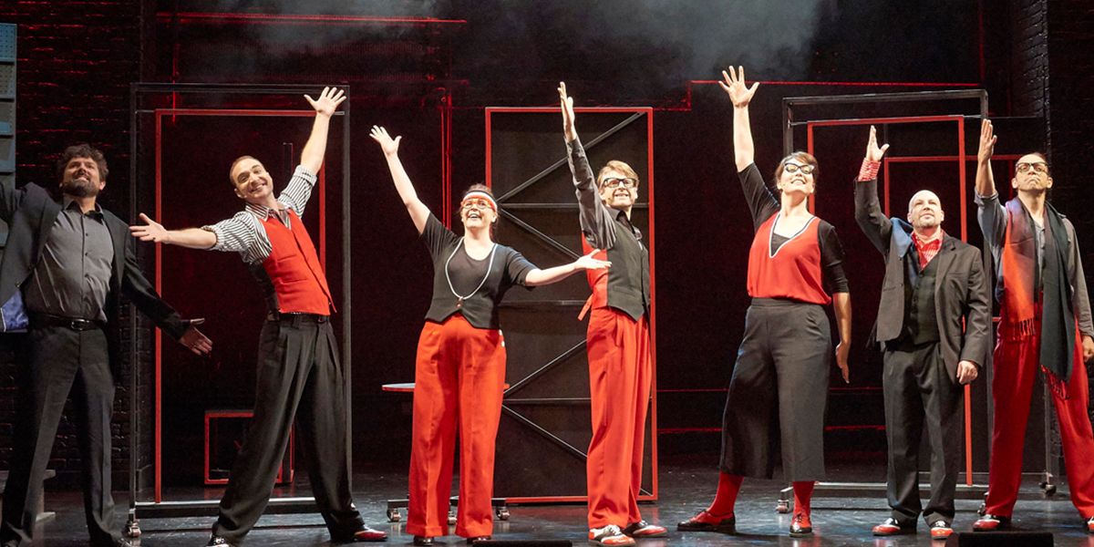 A vibrant stage scene with performers in colourful costumes, energetically engaging in a musical number.