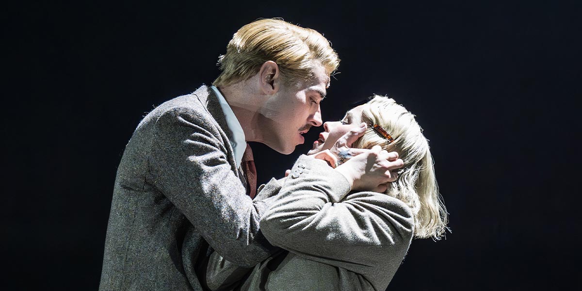 Matt Willis as Emcee and Katie Hall as Sally Bowles perform on stage, dressed in vibrant costumes.