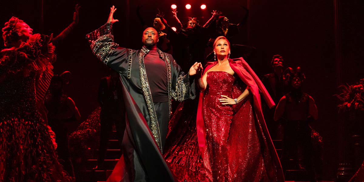 Matt Henry and Vanessa Williams in costume, engaged in a dramatic scene from The Devil Wears Prada.