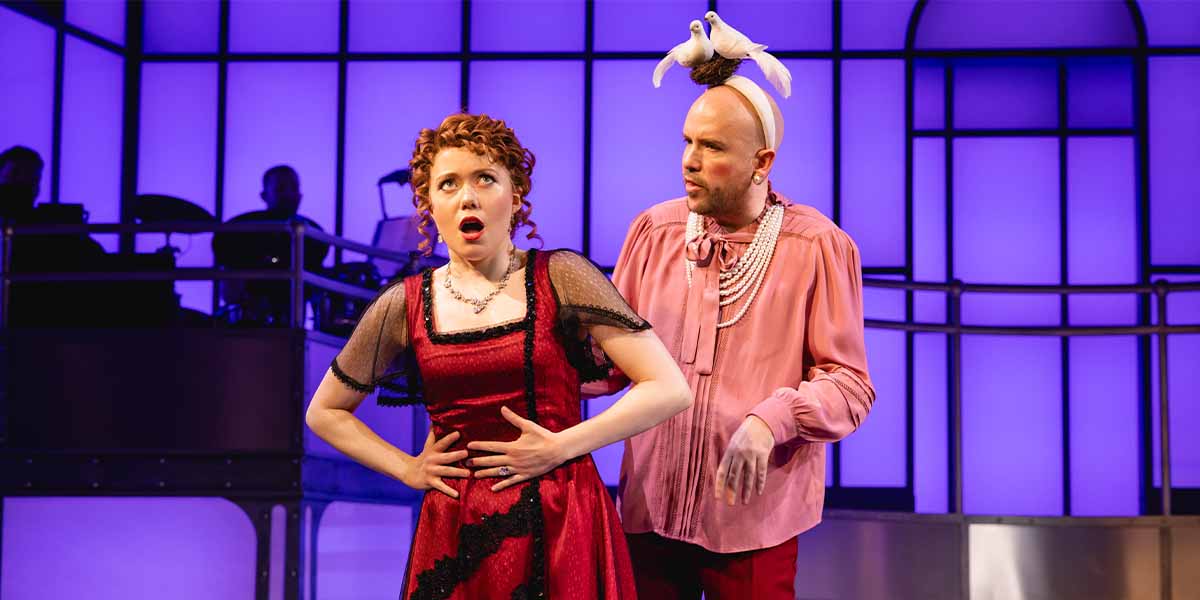 Rose Galbraith, in a red dress, looks shocked while Tom Allen, in pink, gestures dramatically.
