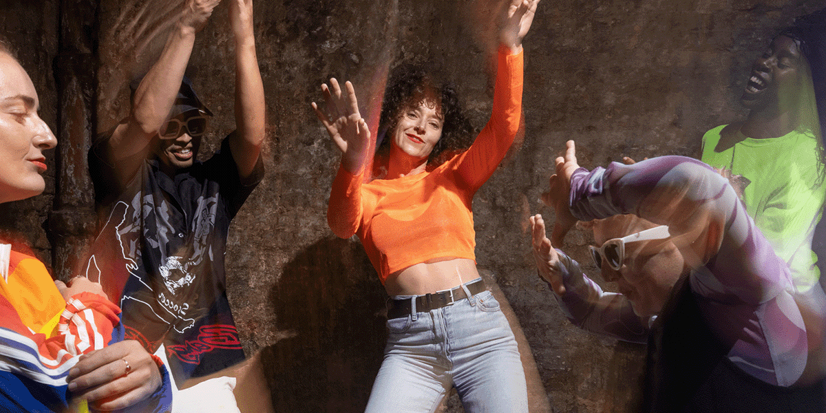 A group of people dancing in brightly coloured outfits.