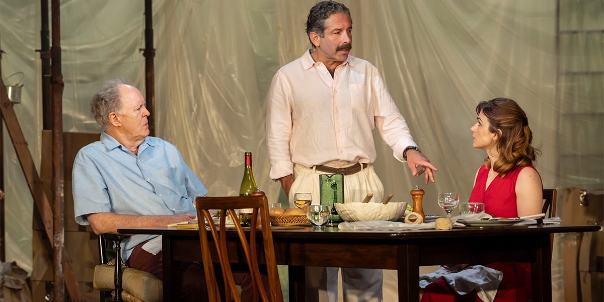 Aya Cash (Jessica Stone) Elliot Levey (Tom Maschler) and John Lithgow (Roald Dahl) are sitting at a large brown table.