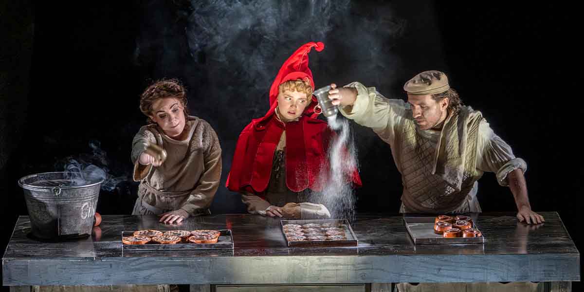 Rachel Tucker, Gracie McGonigal, and Hughie O'Donnell prepare pastries, with smoke and flour in the air.