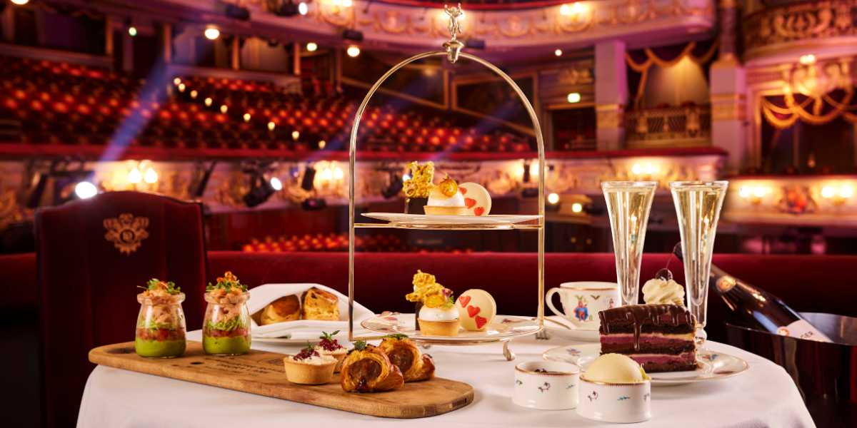 The image shows an afternoon tea setup inside a theatre.