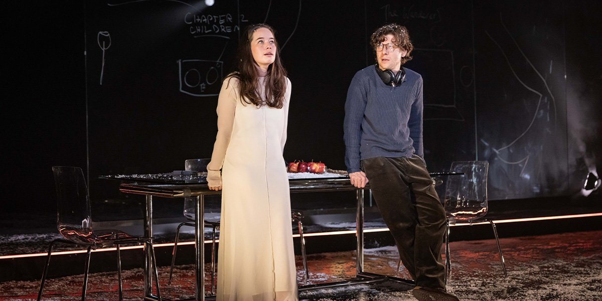 Anna Popplewell as Julia and Alexander Forsyth as Abe stand together, smiling, in a softly lit setting.