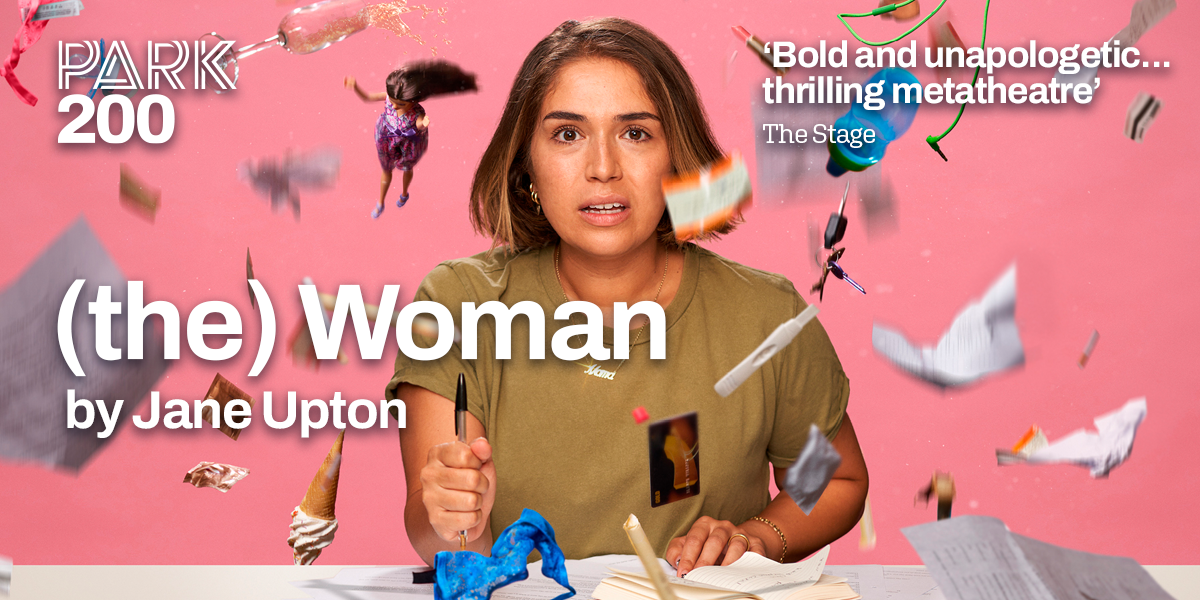 The background is pink. In the centre is an image of a person with shoulder length, light brown hair. On the left it reads '(The) Woman'