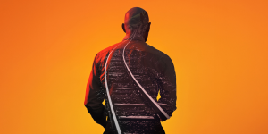 The background is orange. In the centre a silhouette can be seen of a person, inside the silhouette are train tracks.