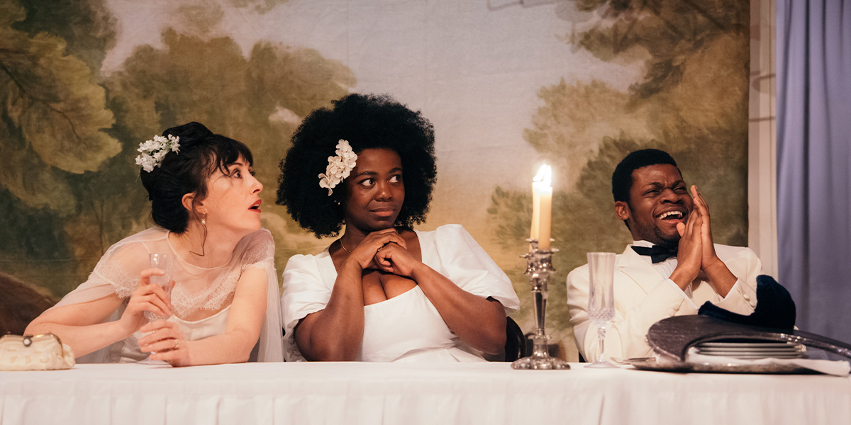 A scene from "A Midsummer Night's Dream" featuring actors in elaborate costumes amidst a forest backdrop.