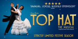 Two people, one wearing a white dress and the other a black suit dance together. Text reads 'Top Hat'.