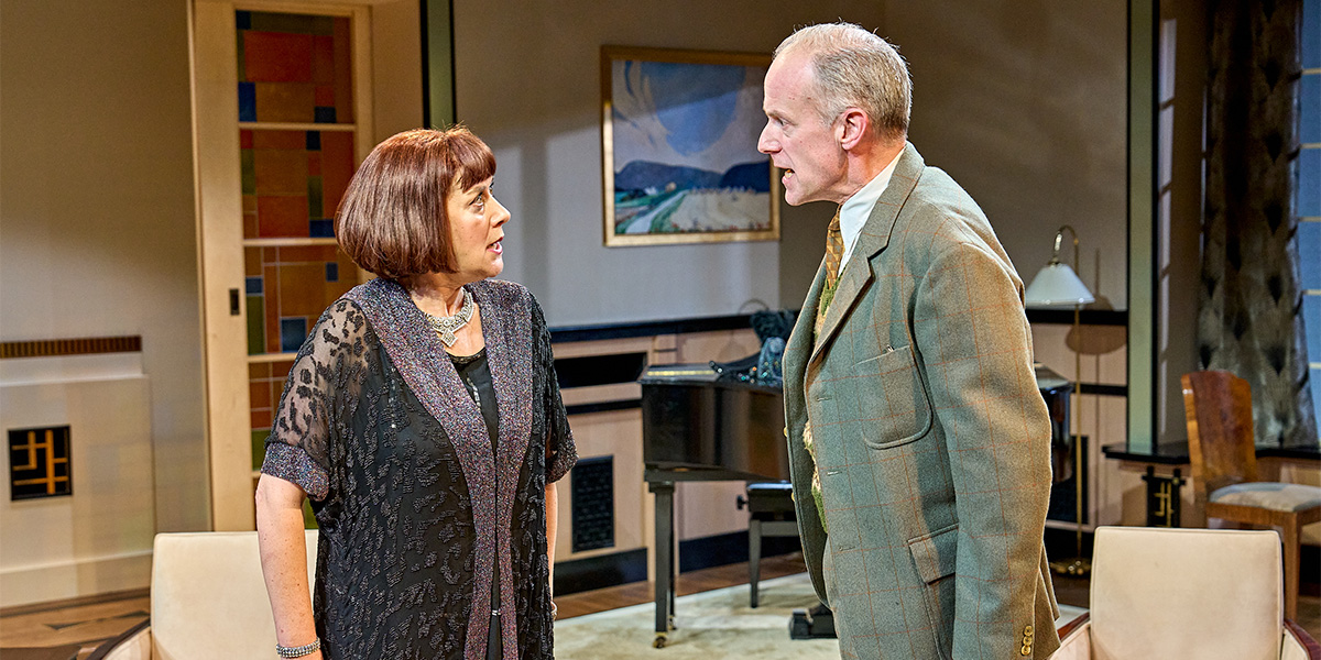 Alexandra Gilbreath as Jane Banbury and Richard Teverson as Fred Steroll in a theatrical scene.