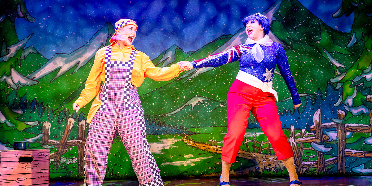 Laura Anna-Mead and Dani Mirels pose together in costume for "Beauty and the Beast," smiling warmly.