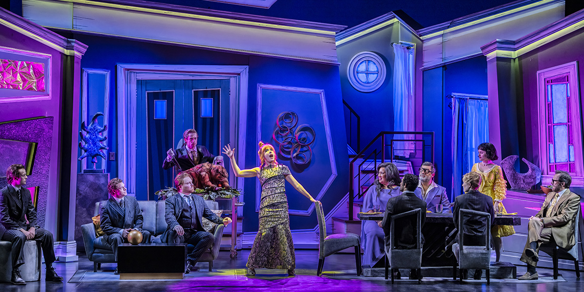 A scene from Beetlejuice The Musical featuring vibrant costumes and theatrical lighting on stage.
