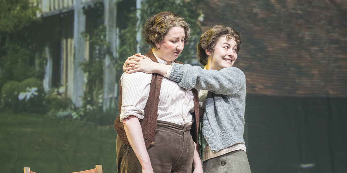 Maggie Service and Ruby Ashbourne Serkis pose together, smiling, in a brightly lit theatre setting.
