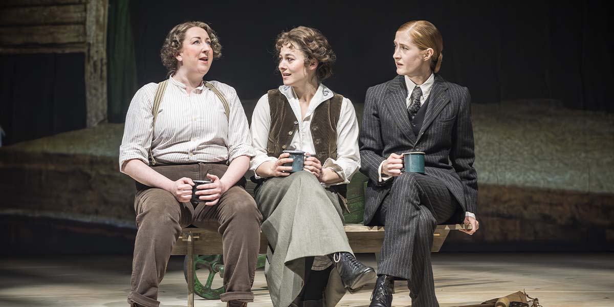Maggie Service, Ruby Ashbourne Serkis, and Kathryn Wilder pose together, smiling, in a theatre setting.