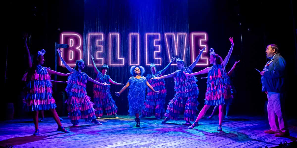 Nicole Nyarambi as Garage Girl and Mark Addy as Harold Fry pose together on stage.
