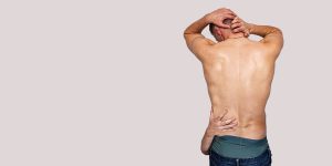 A vibrant theatre exterior with red and gold signage, featuring a crowd of people entering the venue.