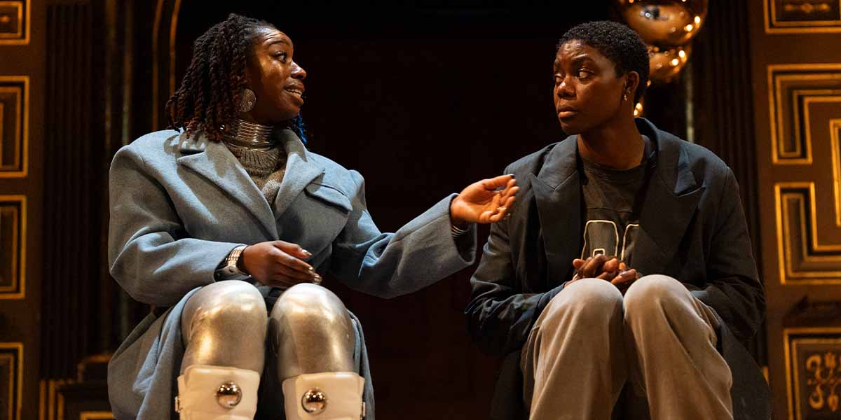 Aminita Francis as SK Good and Selina Jones as Azure engage in conversation on stage at Shakespeare's Globe.