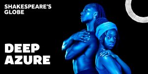 A man and a woman pose back-to-back, illuminated in blue light against a black background.