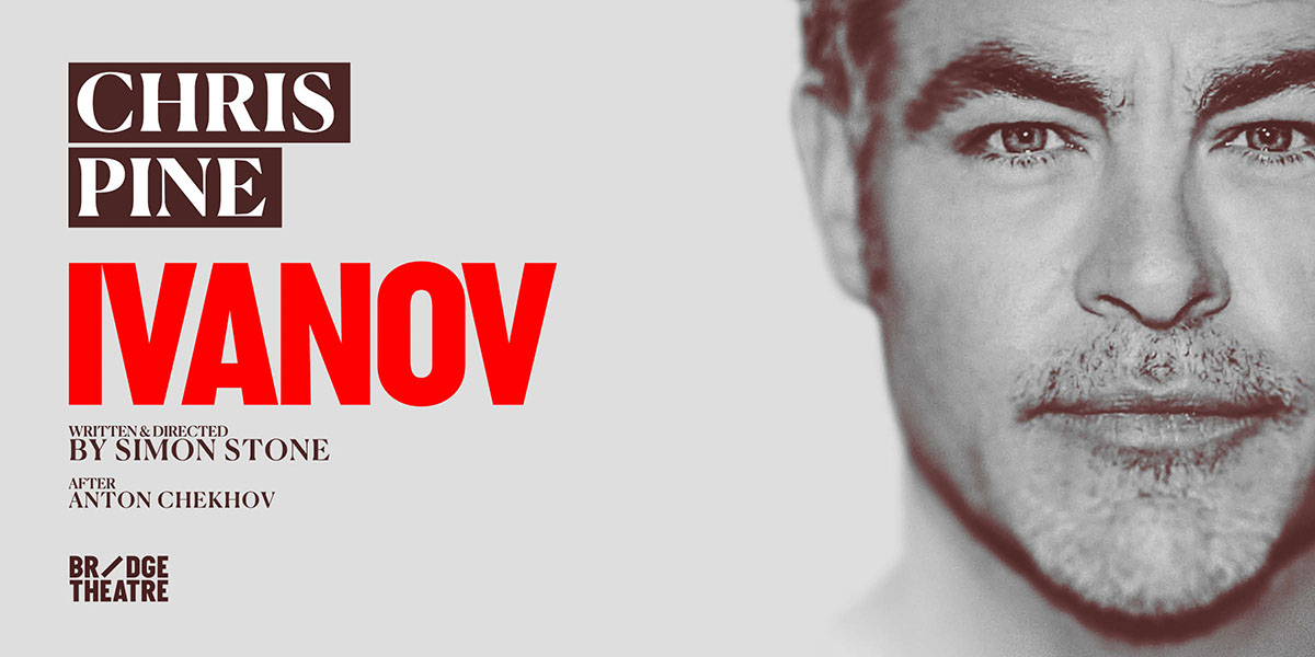 A professional man in a suit stands confidently, arms crossed, against a blurred office background.