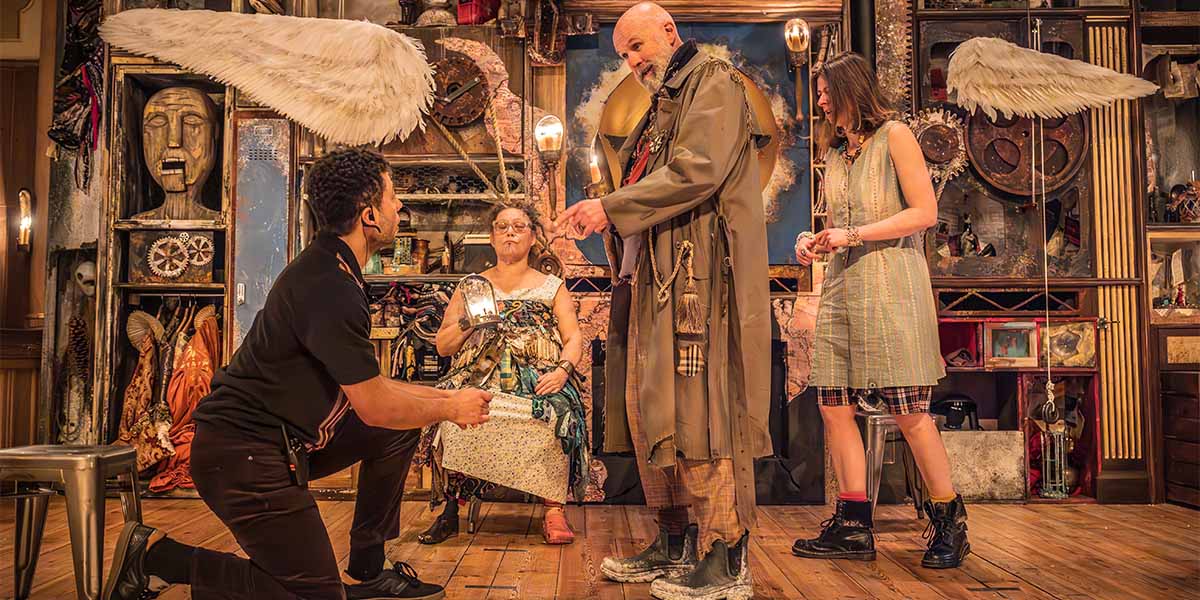 A dramatic scene from "The Tempest," featuring actors in period costumes on a stage with atmospheric lighting.
