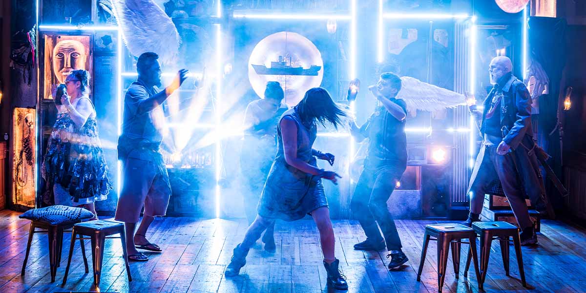 The cast of The Tempest performing on stage at Shakespeare's Globe, dressed in period costumes.