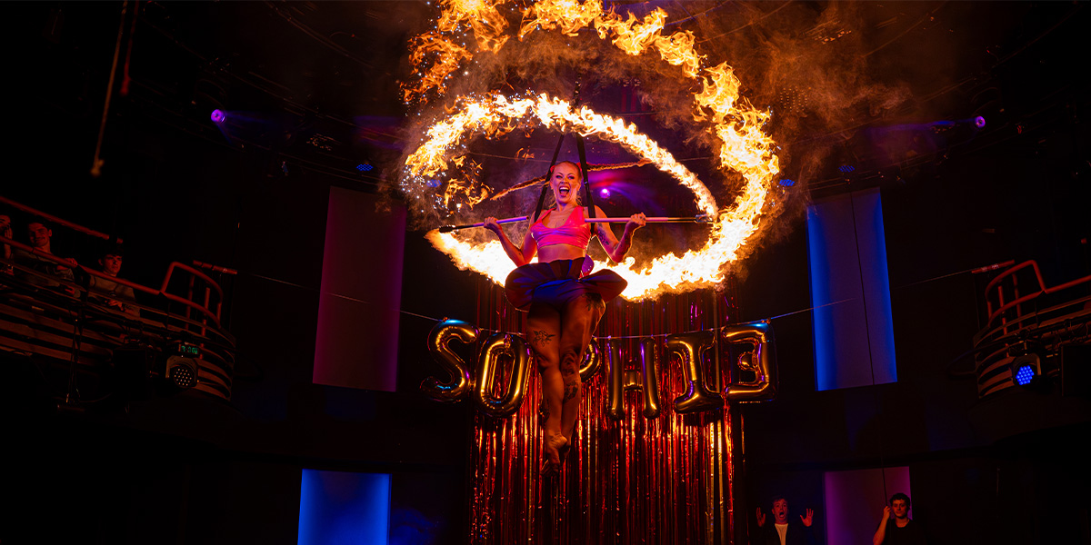 A person sits inside a ring of fire.