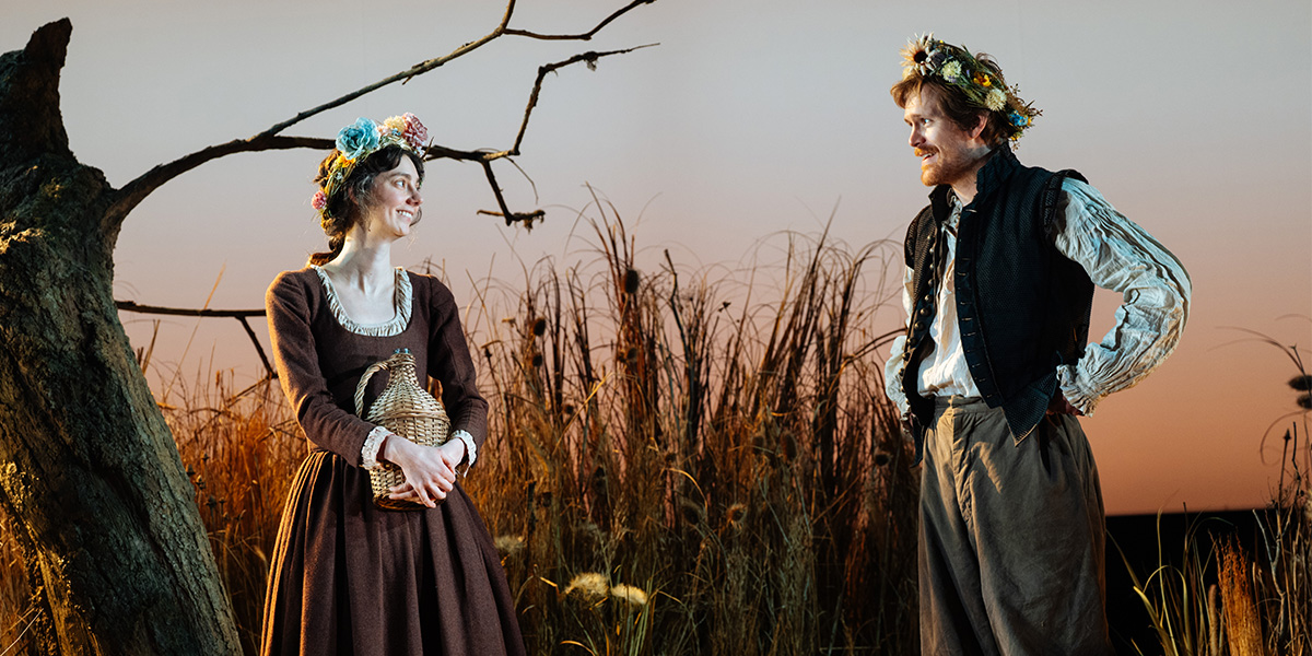 Tanya Reynolds and George Kemp pose together, smiling, against a blurred background. Photo by Helen Murray.