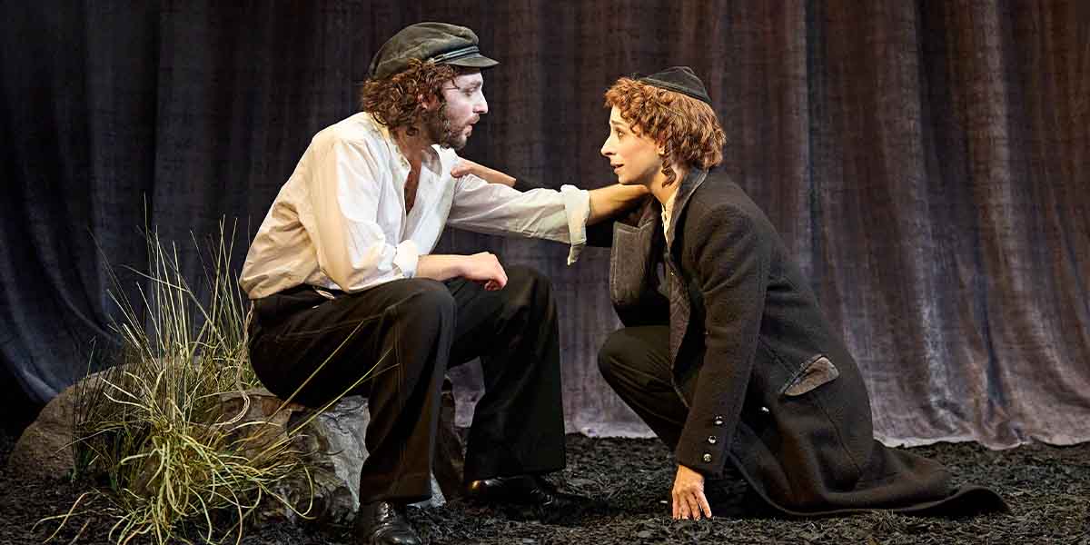 Ashley Margolis as Avigdor and Amy Hack as Yentl share an intimate moment on stage.