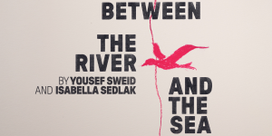 A serene landscape featuring a river bordered by lush greenery and a calm sea in the background.