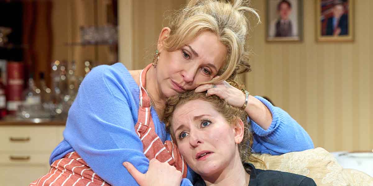 Tracy-Ann Oberman comforts Dorothea Myer-Bennett, both displaying emotional expressions in a domestic setting.