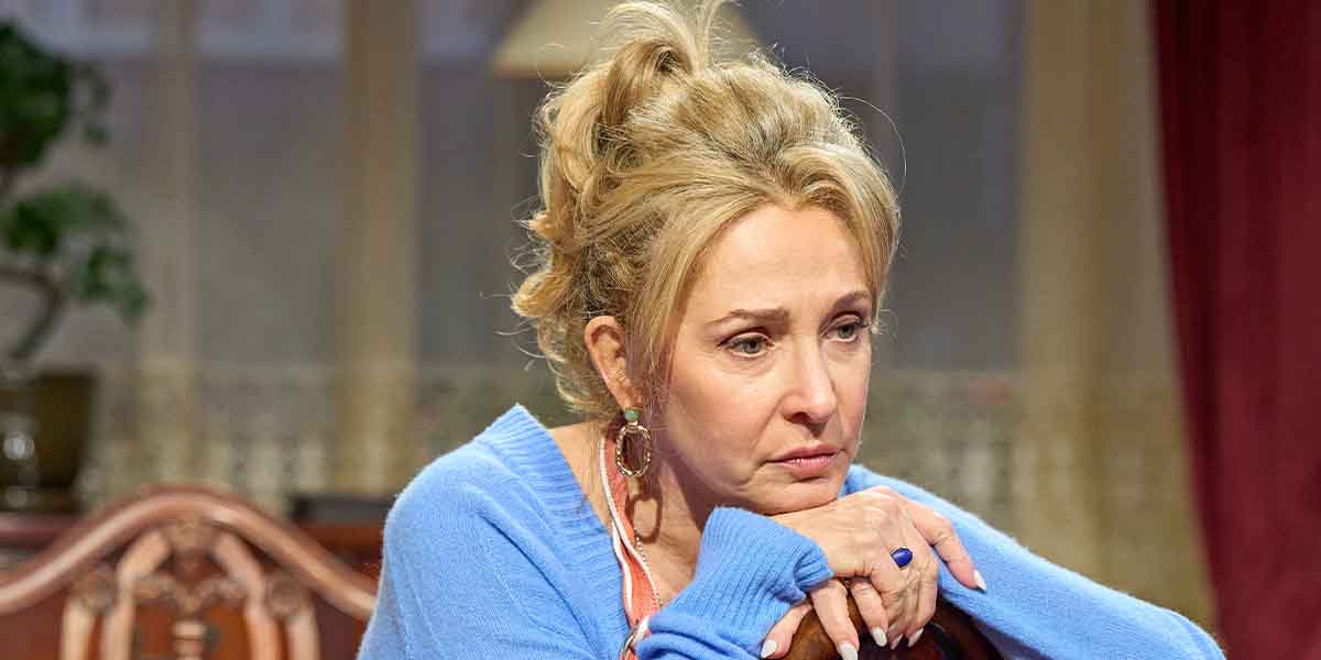 Tracy-Ann Oberman, portraying Lesley Rosenberg, looks pensive while resting her chin on her hands.