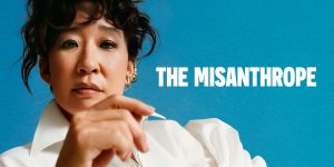 Elizabeth Yule as Alceste, dressed in period costume, stands centre stage with a dramatic expression.