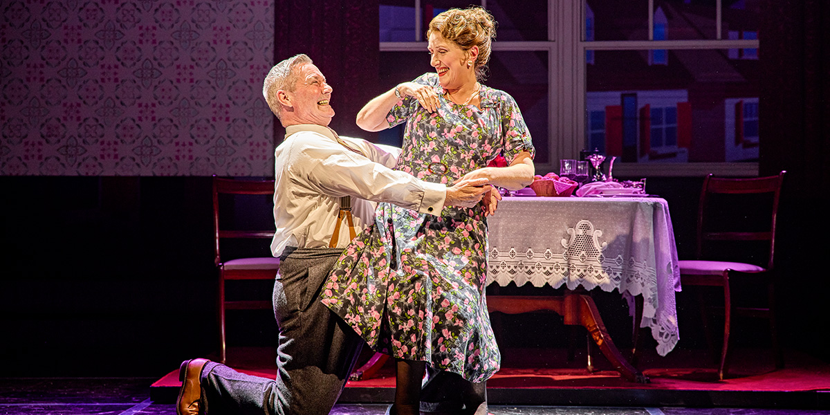 Jenna Russell and Marty MacGuire perform on stage in Sinatra The Musical, with dramatic lighting and vibrant costumes.