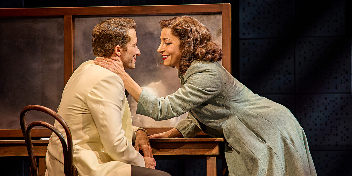 Joel Harper-Jackson and Phoebe Panaretos perform on stage in Sinatra The Musical, surrounded by dramatic lighting.