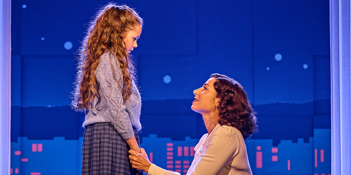 Phoebe Panaretos and Mia Savident perform on stage in Sinatra The Musical, with dramatic lighting and vibrant costumes.
