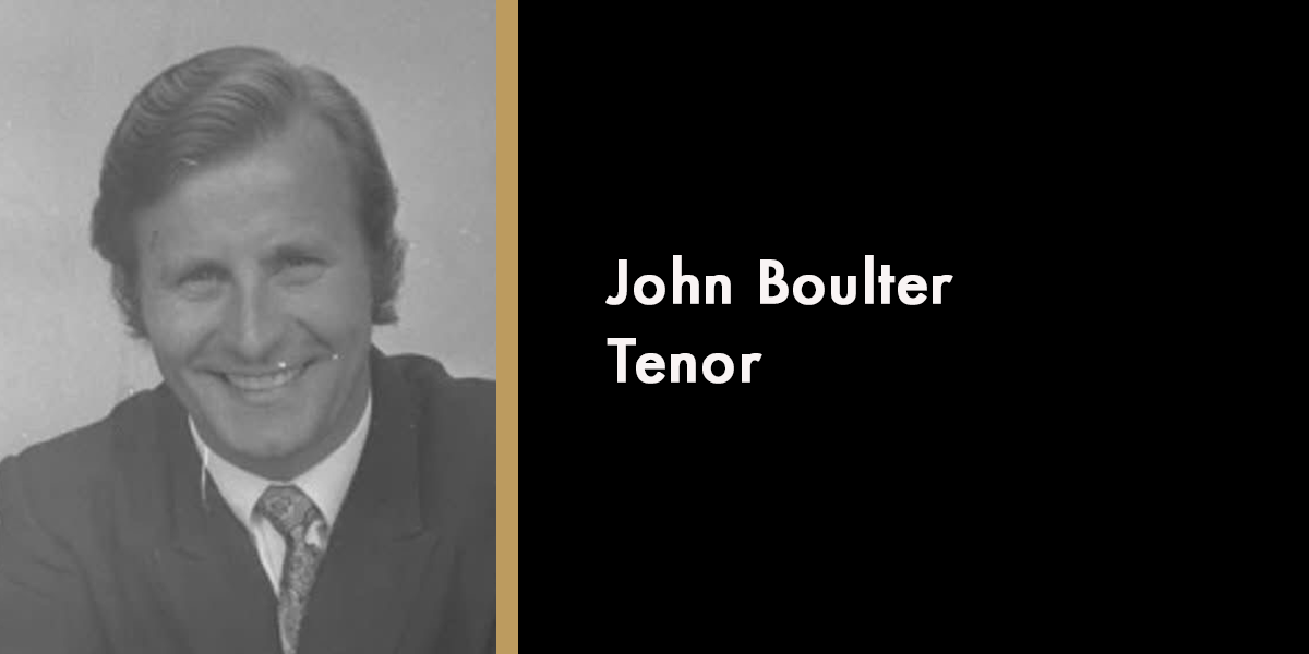 A portrait of John Boulter, smiling, wearing a suit against a neutral background, with a memorial date of 2026.