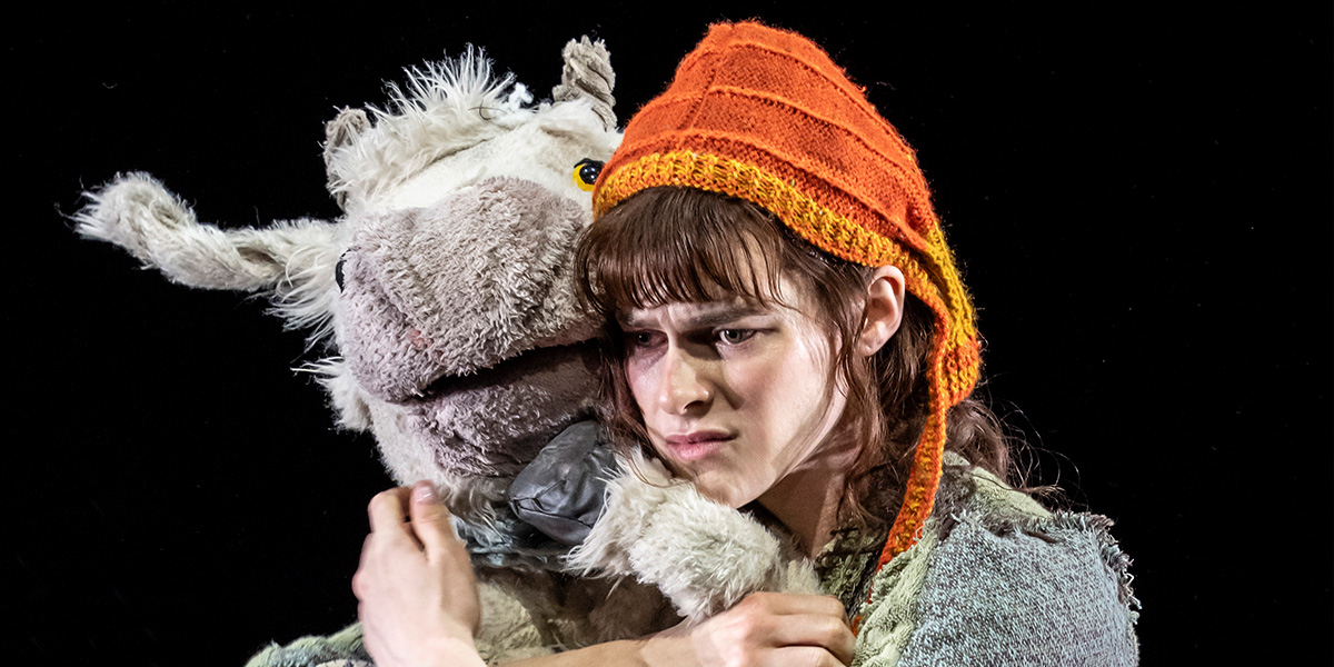 Jo Foster as Jack hugs a white toy cow.