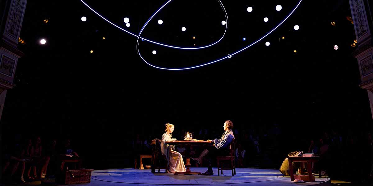 Yolanda Kettle as Lady Croom and Seamus Dillane as Septimus Hodge seated at a table, illuminated.