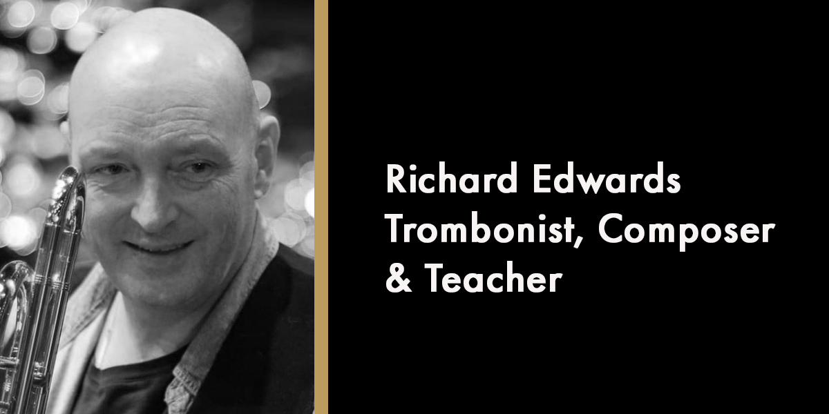 A portrait of Richard Edwards, smiling, with a dark background and soft lighting, commemorating his memory.