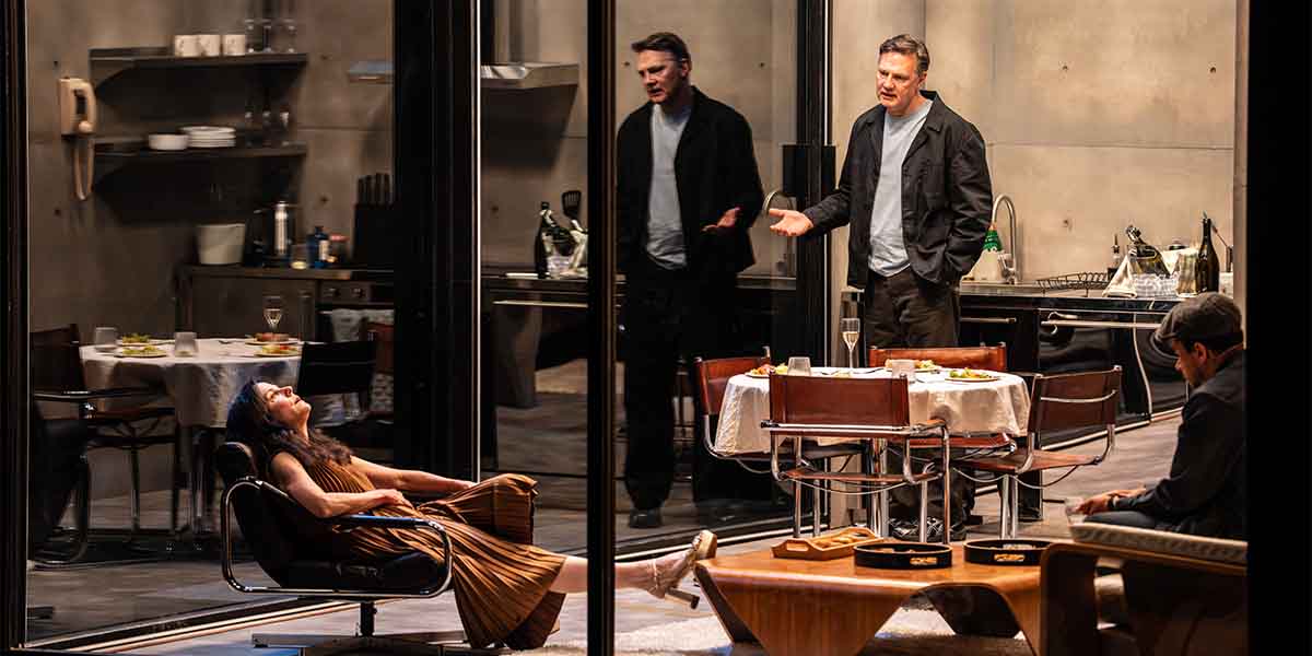 Mary-Louise Parker reclines in a chair, while David Morrissey gestures animatedly and John Macmillan observes.