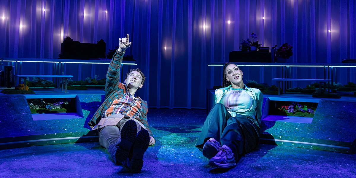 A vibrant set design featuring colourful props and lighting, with a focus on creative staging elements.