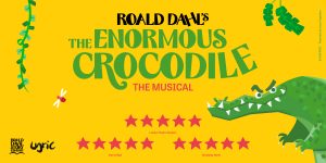 A vibrant scene from "The Enormous Crocodile The Musical" featuring a large crocodile and jungle backdrop.