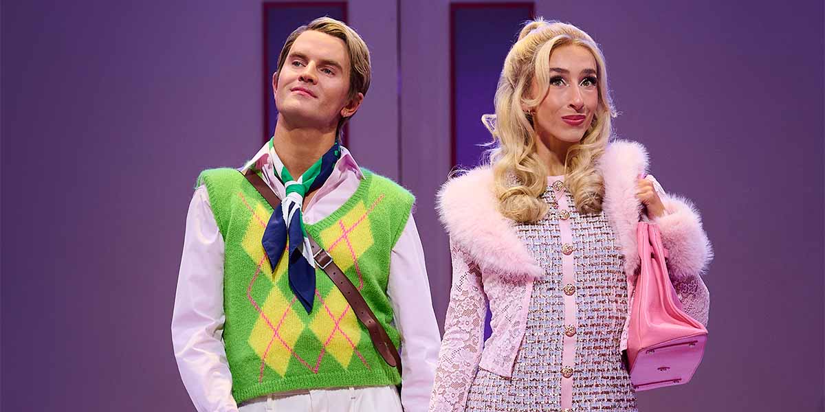 Luke Bayer as Ryan Evans and Caitlin Tipping as Sharpay Evans perform on stage in vibrant costumes.