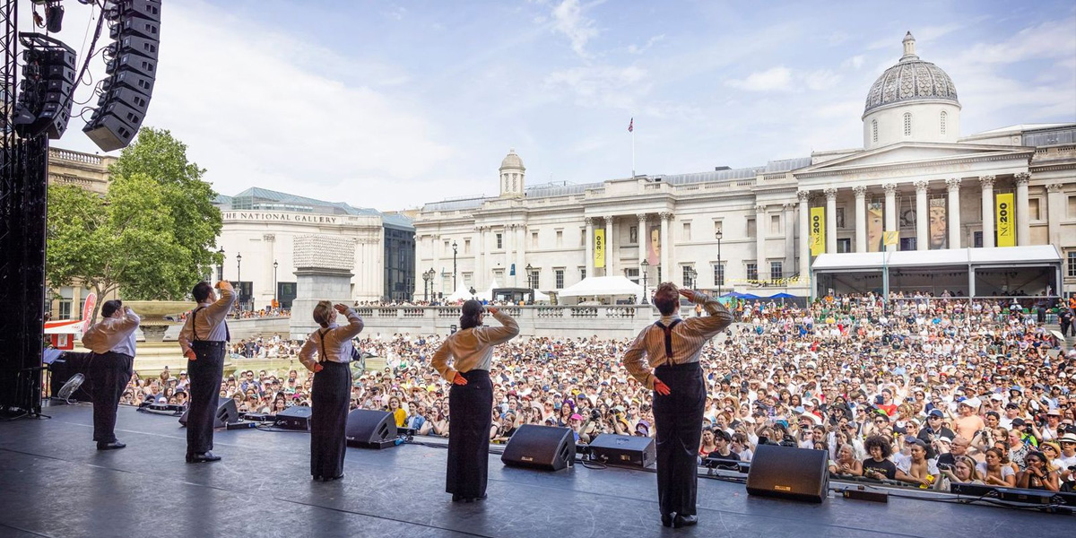 Backstage view of Operation Mincemeat performers with a large, cheering crowd at West End LIVE 2025.