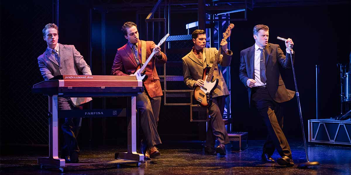 Toby Miles, Carlo Boumouglbay, Lewis Kennedy, and Luke Baker perform on stage in Jersey Boys.